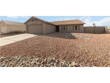Single-story home with xeriscaped yard, two-car garage and neutral color palette at 383 Virginia Lake Ave, Henderson, NV 89015