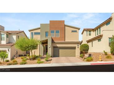 Contemporary two-story home boasts desert landscaping, neutral tones, and an attached two-car garage at 6901 Whisper Canyon Pl, North Las Vegas, NV 89084