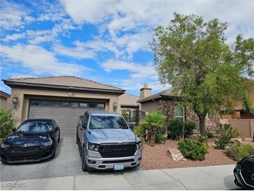Charming single-story home featuring stone accents, a well-manicured lawn, and a spacious two-car garage at 8564 Mayport Dr, Las Vegas, NV 89131
