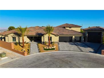 Stunning single-story home featuring a tile roof, desert landscaping, and a three-car garage at 9865 Bright Angel Way, Las Vegas, NV 89149