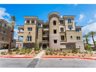 Beautiful multi-story building with desert landscaping and a unique rounded tower feature at 128 Los Cabos Dr # 301, Las Vegas, NV 89144