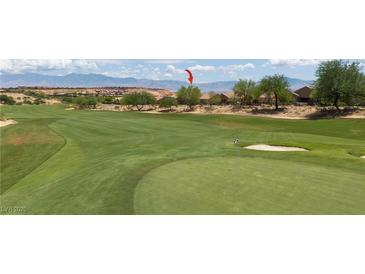 Scenic view of a lush green golf course with mountains in the background at 1407 Wheelwright Ct, Mesquite, NV 89034
