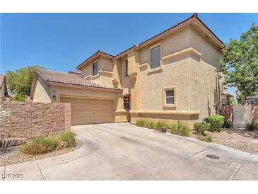 Two-story home showcasing desert landscaping, private driveway, and a two-car attached garage at 1476 Evening Song Ave, Henderson, NV 89012