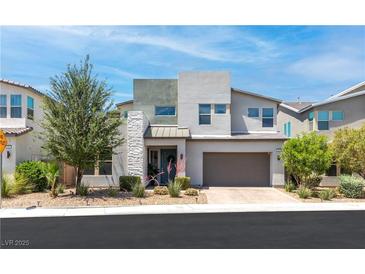 Contemporary two-story home boasting a neutral color scheme, manicured landscaping, and a spacious two-car garage at 298 Grant Ridge Dr, Henderson, NV 89012