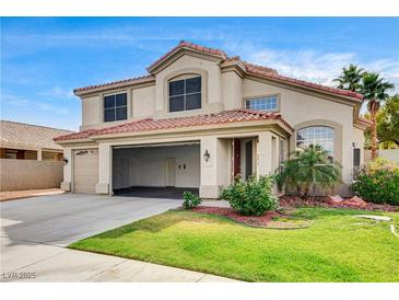 Charming two-story home with a tile roof, spacious three-car garage, and well-manicured front lawn at 313 Vista Glen St, Las Vegas, NV 89145