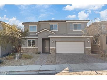 Charming two-story home featuring a two-car garage, stone accents, neutral paint, and a well-maintained front yard at 340 Autumn Palace Ct, Las Vegas, NV 89144