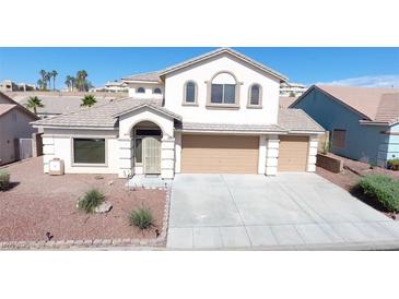 Charming two-story home featuring a well-maintained front yard and attached two-car garage at 2905 Shimmering Bay St, Laughlin, NV 89029