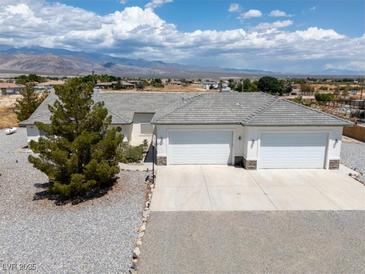 Expansive ranch-style home with attached two-car garage and beautiful mountain views at 3451 Sagebrush Ave, Pahrump, NV 89048