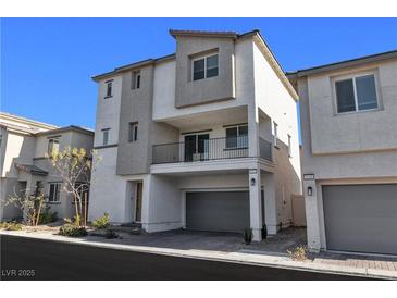 Contemporary three-story townhome with a private balcony and a two-car garage at 6952 Crescent Gold St, North Las Vegas, NV 89086