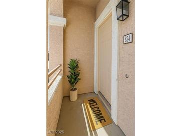 Inviting entryway featuring a welcome mat and a potted plant, leading into the home at 830 Carnegie St # 824, Henderson, NV 89052