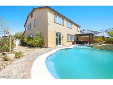 Backyard pool view showcases refreshing water, covered patio, and outdoor leisure space at 1141 Brent Park Ct, Henderson, NV 89002