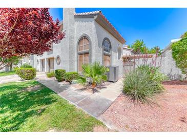 Charming two-story home with beautiful landscaping, mature trees, and a well-maintained stucco facade at 208 Genesee Point St, Henderson, NV 89074