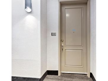 Condo front door with access number and modern sconce lighting at 38 E Serene Ave # 134, Las Vegas, NV 89123