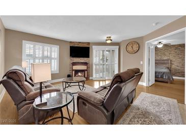 Cozy living room features a fireplace, comfortable seating, and ample natural light from shuttered windows at 6800 E Lake Mead Blvd # 2089, Las Vegas, NV 89156