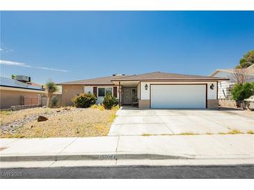Charming single story home with a well maintained lawn, mature landscaping, and a two car garage at 7701 Pheasant Ln, Las Vegas, NV 89145