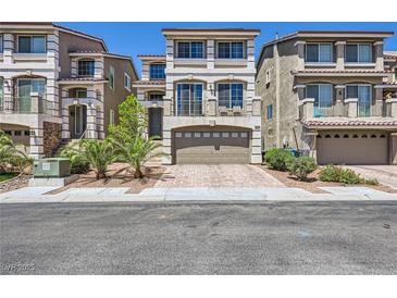 Attractive multi-story home featuring desert landscaping, a two-car garage, and a private balcony at 8121 Russell Creek Ct, Las Vegas, NV 89139