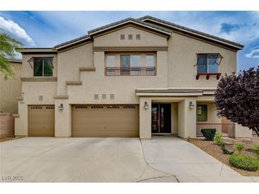Stunning two-story home with a three-car garage and immaculate front yard landscaping at 8223 Saddleback Ledge Ave, Las Vegas, NV 89147