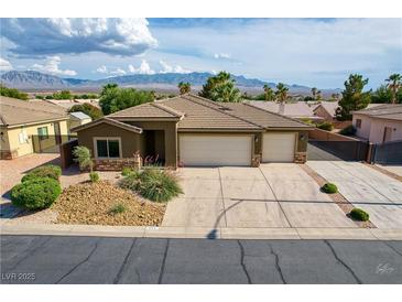 Charming single-story home featuring a three-car garage and a well-maintained front yard at 854 Santa Maria Way, Mesquite, NV 89027
