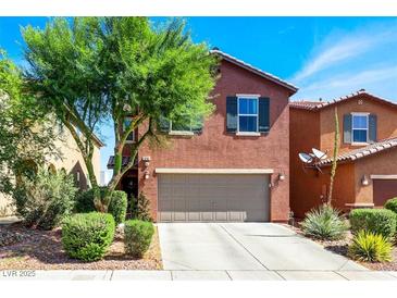 Charming two-story home featuring a well-maintained front yard, a driveway, and a two-car garage at 9236 Keystone Ridge Ave, Las Vegas, NV 89148