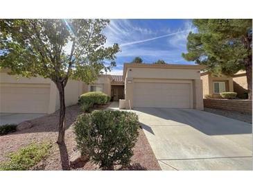 Charming single-story home featuring an attached two-car garage and desert landscaping at 10065 Hemet Dr, Las Vegas, NV 89134