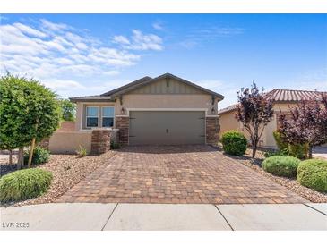 Charming single-story home with well-maintained landscaping and a brick driveway at 2207 Valdina St, Henderson, NV 89044