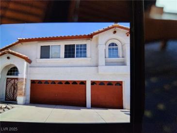 Charming two-story home with a two-car garage and well-maintained front yard, perfect for Gathering living at 2553 Hummingbird Hill Ave, Henderson, NV 89074