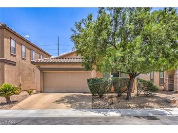 Charming single-story home with a two-car garage and desert landscaping on a sunny day at 5528 Stone Lagoon St, North Las Vegas, NV 89031