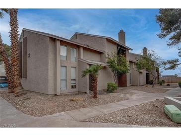 Inviting condo featuring a stucco exterior, desert landscaping, and a welcoming entrance at 573 Sellers Pl, Henderson, NV 89011