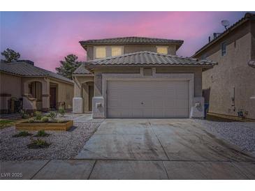 Two-story home with a tile roof, a two-car garage, and low-maintenance landscaping at 5834 Autumn Harvest Ave, Las Vegas, NV 89142