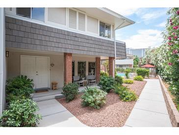 Charming front entrance with double doors, brick accents, and lush landscaping for a welcoming appeal at 794 Oakmont Ave # 106, Las Vegas, NV 89109