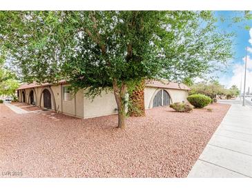 Charming single-story home featuring arched entryways, desert landscaping, and mature shade trees at 848 Hedge Way # 5, Las Vegas, NV 89110