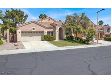 Charming single-story home featuring a well-manicured lawn, two-car garage and a welcoming entrance at 8612 Chiquita Dr, Las Vegas, NV 89128