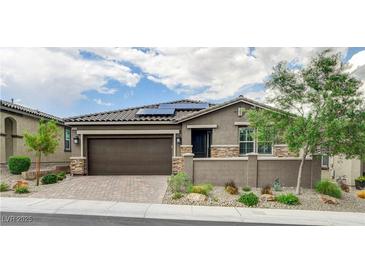 Charming single-story home with desert landscaping, a tile roof, solar panels and a two-car garage at 10182 Skye Run Ave, Las Vegas, NV 89166