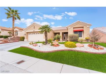 Single-story home featuring desert landscaping, an attached garage, and a well-manicured lawn at 10508 Snyder Ave, Las Vegas, NV 89134