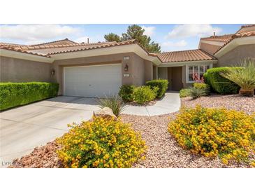 Charming single-story home featuring a well-manicured front yard and a two-car garage at 1912 Summer Pine Ct # 102, Las Vegas, NV 89134