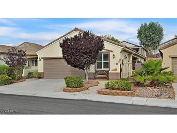 Charming single-story home with a well-manicured front yard and neutral color palette at 2328 Fossil Canyon Dr, Henderson, NV 89052