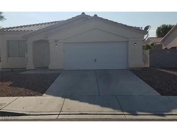 Charming single-story home with a well-maintained front yard and attached two-car garage at 5307 Wild Orchid St, North Las Vegas, NV 89031