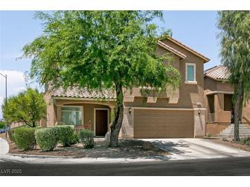 Charming two-story home featuring a well-maintained lawn and an attached two-car garage at 5835 Running Horse Dr, North Las Vegas, NV 89081