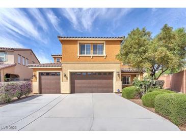 Two-story home with three-car garage, a tile roof, and manicured landscaping enhancing curb appeal at 6659 Alder Flower Ct, North Las Vegas, NV 89084