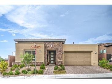 Stylish single-story home with stone accents, desert landscaping, and a two-car garage on a sunny day at 6728 Regency Ridge Ct, Las Vegas, NV 89148