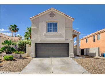 Charming stucco two-story home featuring a two-car garage and desert landscaping at 9328 Jumpin Juniper Ave, Las Vegas, NV 89129