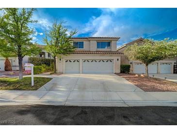 Charming two-story home with a three-car garage and desert landscaping at 9772 Galahad Point Ct, Las Vegas, NV 89147