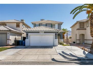 Charming two-story home showcasing a well-maintained lawn, attached two-car garage, and a classic tile roof at 1352 Angel Falls St, Las Vegas, NV 89142