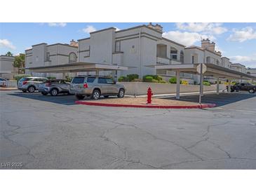 Condominium parking with covered spots and red fire hydrant near the building at 3150 Soft Breezes Dr # 2186, Las Vegas, NV 89128