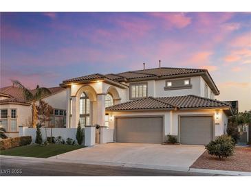 Beautiful two-story home with a tiled roof, arched entryway, and spacious three-car garage at 5225 Villa Dante Ave, Las Vegas, NV 89141