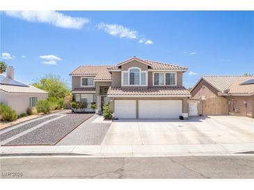 Charming two-story home with a three-car garage, tile roof, and well-maintained landscaping on a sunny day at 747 Canyon Crest Dr, Las Vegas, NV 89123