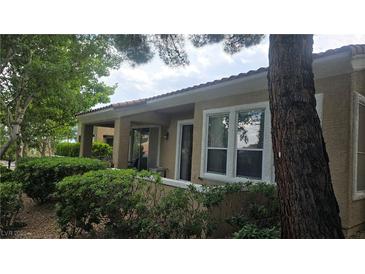 Charming single-story home with lush landscaping and a covered front porch, offering curb appeal and a welcoming entrance at 9900 Summer Ash Ct # 101, Las Vegas, NV 89134