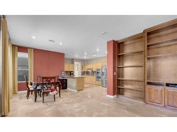 A spacious kitchen features modern appliances, a breakfast bar, and an adjacent dining area with ample natural light at 9900 Summer Ash Ct # 101, Las Vegas, NV 89134