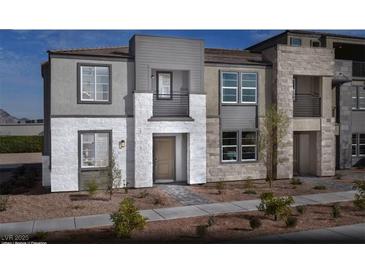 Contemporary three-story home boasts stone and stucco, plus modern windows and a stylish entryway at 1168 Heliodor Ave # Lot 152, Henderson, NV 89011
