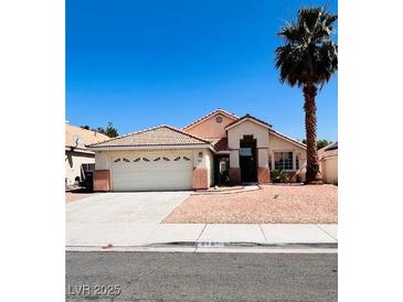 Charming single-story home featuring a well-maintained front yard and two-car garage at 1318 Pine Terrace Ct, North Las Vegas, NV 89031
